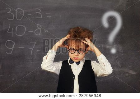 Brooding Boy Elementary School Student At The Blackboard