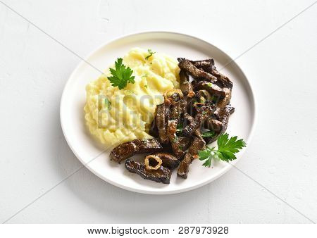 Roasted Beef Liver With Mashed Potatoes On White Plate Over Stone Background. Pieces Liver (offal) F