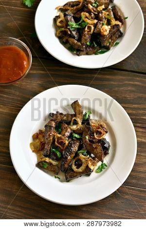 Fried Beef Liver With Onion On Plate Over Wooden Background. Pieces Cooked Liver (offal) From Beef.