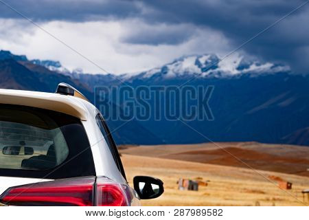 White car back view on mountanious Peru background