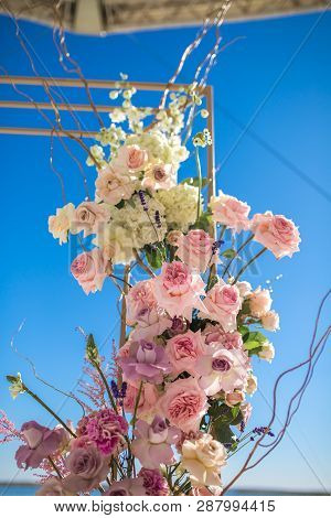 Event Decoration. Wedding Chuppa At Riverside Decorated With Fresh Flowers. Florist Workflow.