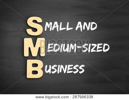Wooden Alphabets Building The Word Smb - Small And Medium-sized Business Acronym On Blackboard