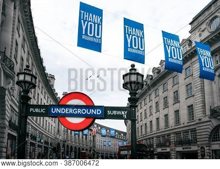 London - 08 August 2020 - Piccadilly Underground Tube Station Sign With Nhs Thank You Banners Post L