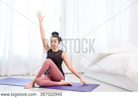 Young Woman Do Yoga In A Bed Room