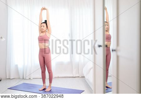 Young Woman Do Yoga In A Bed Room