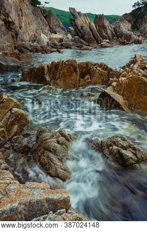 Rock And Sea With A Blurred Wave, Sea Rocky Coastline Telyakovsky Bay Primorsky Krai Russia.