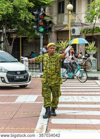 George Town, Penang, Malaysia - December 1, 2019: Street Traffic Warden Is Working At Intersection I
