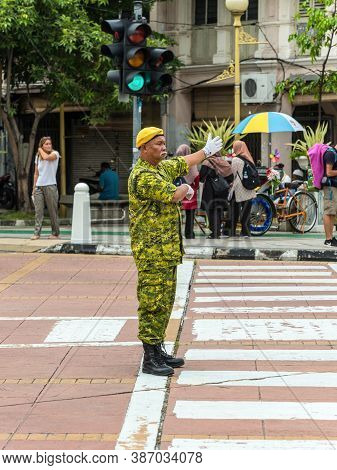 George Town, Penang, Malaysia - December 1, 2019: Street Traffic Warden Is Working At Intersection I