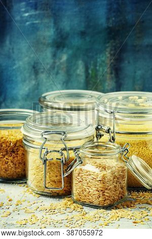 Assorted Cereals In Glass Jars: Kinoa, Bulgur, Couscous, Orzo, Brown Rice, Selective Focus