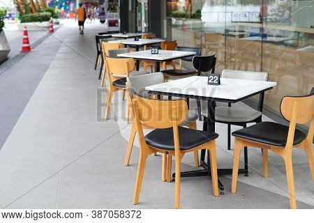 Chair And Dining Table Prepared In The Area Beside The Restaurant For Serving Walkway Area