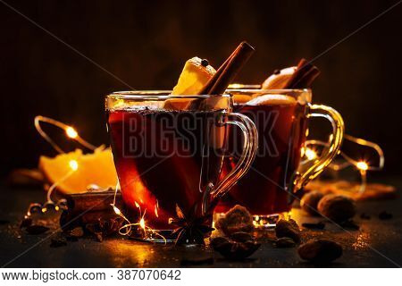 Christmas Mulled Red Wine With Spices And Fruits On Wooden Rustic Table. Traditional Christmas Or Ne