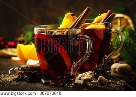 Xmas Hot Mulled Red Wine With Spices And Orange On Wooden Rustic Table. Traditional Christmas Or New