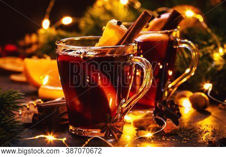 Christmas Mulled Red Wine With Spices And Fruits On Wooden Rustic Table. Traditional Christmas Or Ne