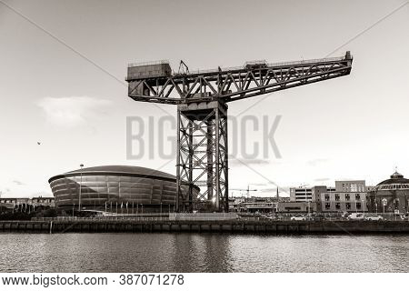 GLASGOW, UK - FEB 26, 2020: The Finnieston Crane or Stobcross Crane stand at waterfront of city center in Scotland, United Kingdom as the symbol of engineering heritage