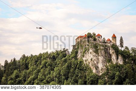 Helicopter Flying Towards The Castle In Bled