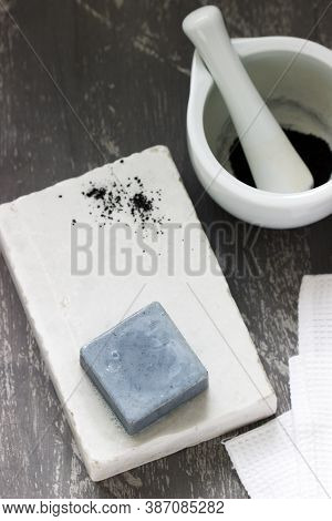 Handmade Soap With Activated Carbon On Marble, Carbon Powder And A Cotton Towel On A Gray Background