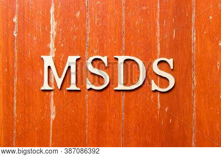 Alphabet Letter In Word Msds (abbreviation Of Material Safety Data Sheet) On Old Red Color Wood Plat