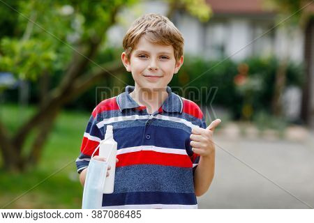 School Kid Boy With Medical Mask As Protection Against Pandemic Coronavirus Quarantine Disease. Chil