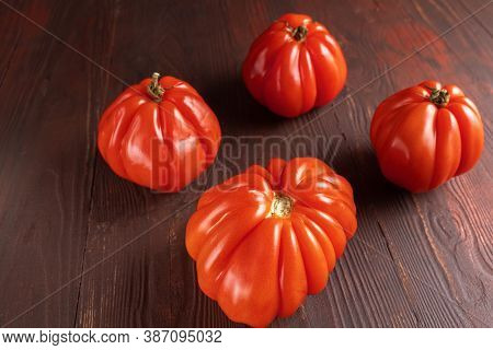 Close Up Of Red Ripe Tomatoes On A Wooden Board. Funny, Weird Vegetable. Ugly Food.