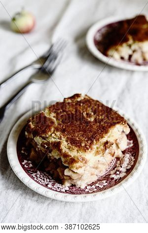Apple And Cheese Cobbler Crisp. Cobbler Or Crumble Dessert With Apples On Plates On Beige Linen Tabl