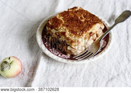 Apple And Cheese Cobbler Crisp. Cobbler Or Crumble Dessert With Apples On Plate On Beige Linen Table