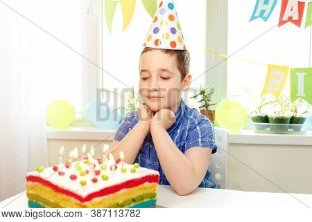 Making A Wish On His Birthday. Beautiful Adorable Eigth Year Old Boy In Blue Shirt, Celebrating His 