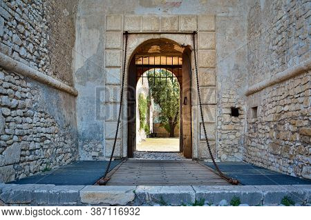 The Stone Walls And The Tower Of The Famous Caetani Castle Of Sermoneta, Little Medieval Town In The