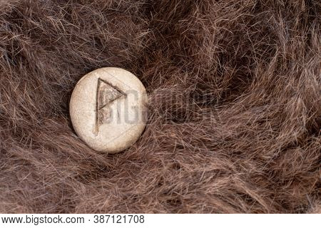 Wunjo Nordic Stone Rune On Animal Fur. Letter Wyn Of The Viking Alphabet.