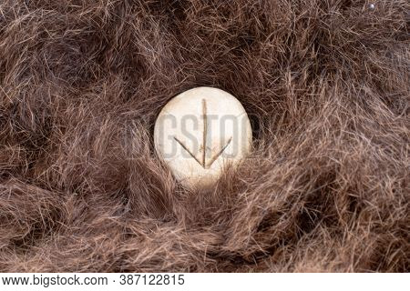 Teiwaz Nordic Stone Rune On Animal Fur. Letter Tiwaz Of The Viking Alphabet.