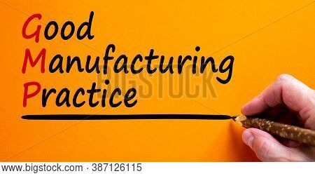 Hand Writing 'gmp, Good Manufacturing Practice', Isolated On Beautiful Orange Background. Business C