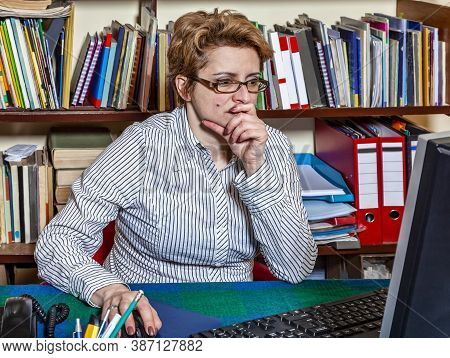 Image Of A Busy Woman Teleworking At Her Desk At The Home. Working At Home Became An Important Recom