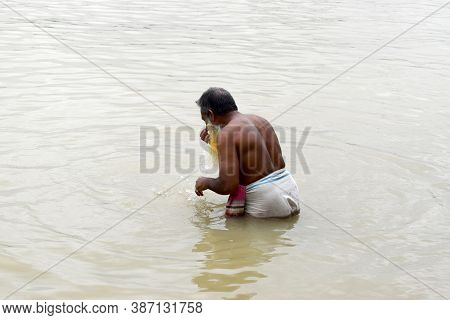 A Man Is Performing Ablution In The River Water,the Photo Was Taken From Shitolokkha River, Narayang