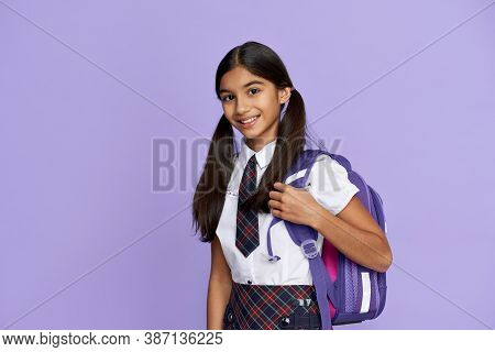 Happy Smiling Indian Preteen Girl, Latin Kid Schoolgirl With Ponytails Wears Uniform Holding Backpac