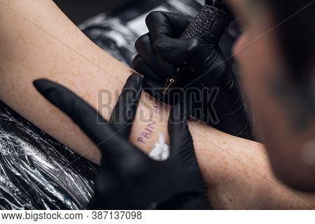 The Process Of Tattooing On A Womans Hand Inscriptions In French Printemps -- Spring. Close-up In A 