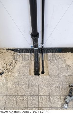 A Black Polypropylene Drain Pipe Worked Into The Floor