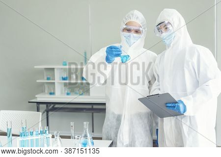 Two Asian Scientist Team Reserch Chemistry Science Tube Experiment Biotech Antibody Sample In Labora