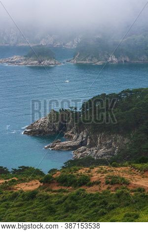 Rocks And Grotto On The Seashore, Foggy Day At Sea, Coastline Of Telyakovsky Bay Primorsky Krai, Rus