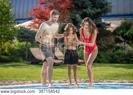 Dad Mom And School Son Near The Pool