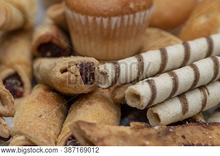 On The Platter Is Sweet Pastries, Close-up, Selective Focus. Bagels With Jam, Muffins And Crispy Tub