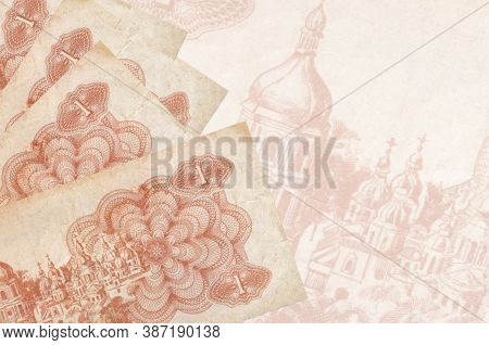 1 Ukrainian Coupon Bills Lies In Stack On Background Of Big Semi-transparent Banknote. Abstract Busi