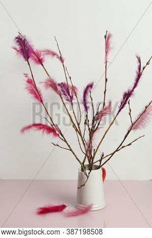 Fastelavnsris decorated with feathres on a table