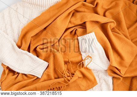 Autumn, Winter Flat Lay Composition. Woolen White Comfort Sweater And Scarf On Light Gray Background
