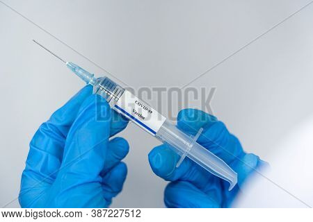 Doctor, Scientist, Researcher Hand In Blue Gloves Or Protective Suit Preparing For Human Clinical In