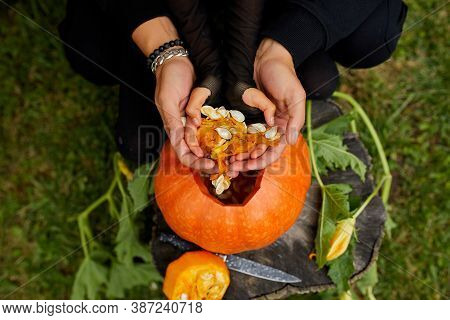Daughter And Father Hands Carving Pumpkin For Halloween, Prepares Jack Olantern
