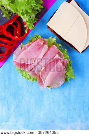 Ingredients For Making Sandwich With Cheese, Pork Balyk, Bell Pepper, Lettuce Leaves And Toasted Bre