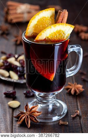 Red Glogg Or Mulled Wine With Orange Slices And Cinnamon Stick On A Dark Wooden Background, Vertical