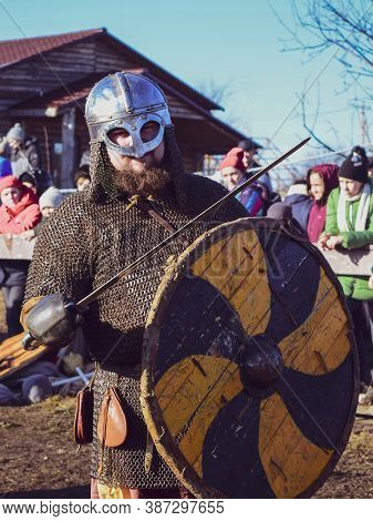 Artist In The Role Of A Viking In A Helmet With A Sword And Shield. Village Argamac Palna. Lipetsk R