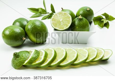 Green Lemon Tahiti Or Citrus Latifolia, Isolated On Neutral Background.