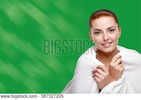 Portrait Of Pretty Redheaded Woman With Fresh Sking And Natural Professional Makeup On A Green Backg