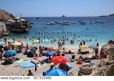 Qala, Malta - August 15, 2019: Many Unidentified People On The Beach Of Hondoq Bay. Island Of Gozo. 